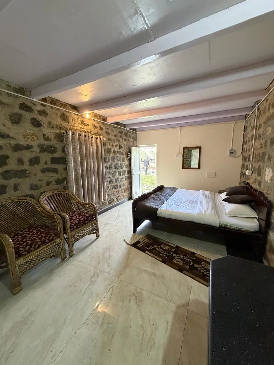 Bedroom with exposed stone wall